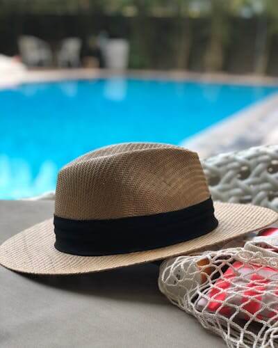 Straw hat next to pool